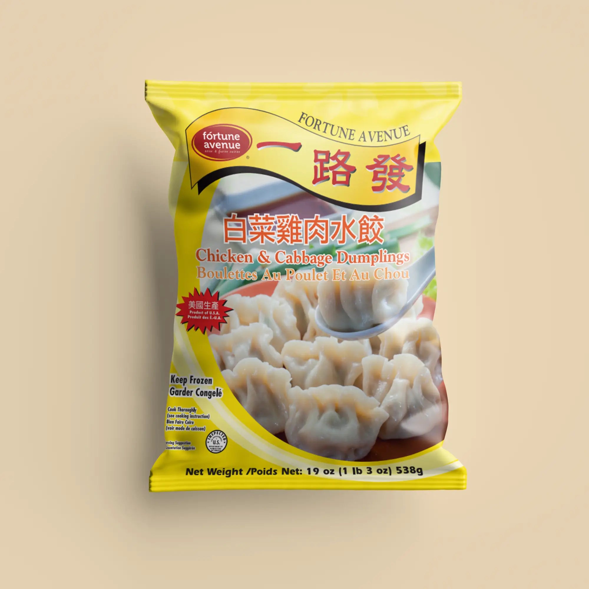 Packaging for Fortune Avenue Chicken & Cabbage Dumplings, featuring a plate of dumplings with one lifted by a spoon, labeled in English and Chinese with a yellow design and product of U.S.A. badge.
